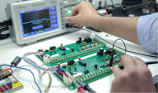 Electronic circuit board being adjusted and measured with an oscilloscope